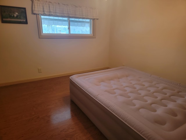 bedroom featuring dark hardwood / wood-style floors