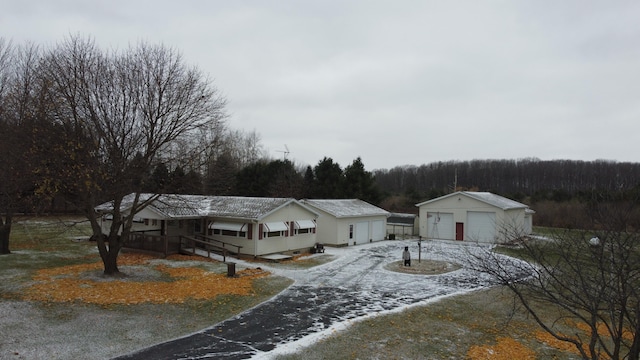 view of front of property featuring a garage and an outdoor structure