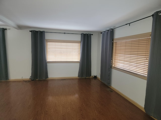 unfurnished room with wood-type flooring