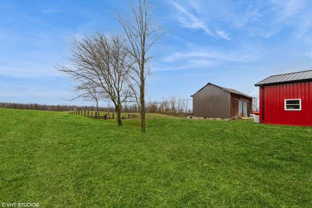 view of yard featuring an outbuilding and a rural view