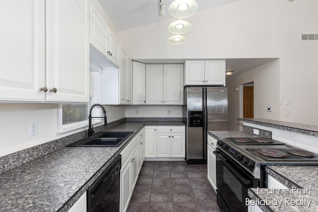 kitchen with sink, dark tile patterned floors, lofted ceiling, white cabinets, and black appliances