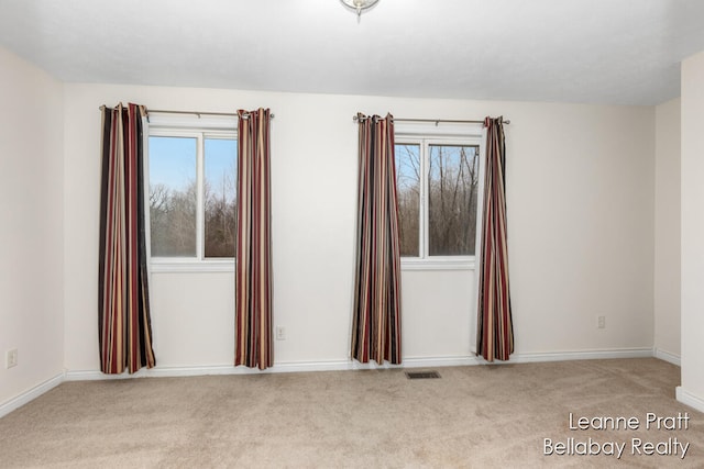 empty room with light colored carpet