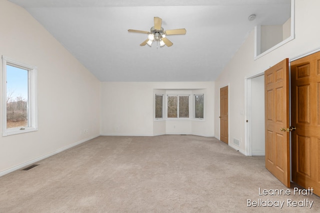 interior space featuring light colored carpet, high vaulted ceiling, and ceiling fan