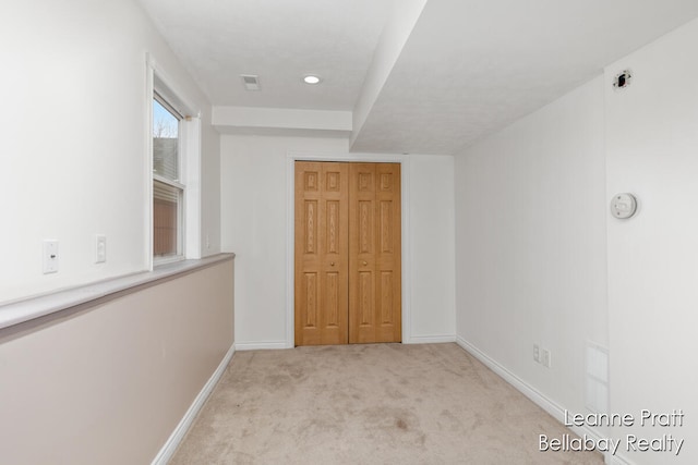 interior space with light colored carpet and a closet