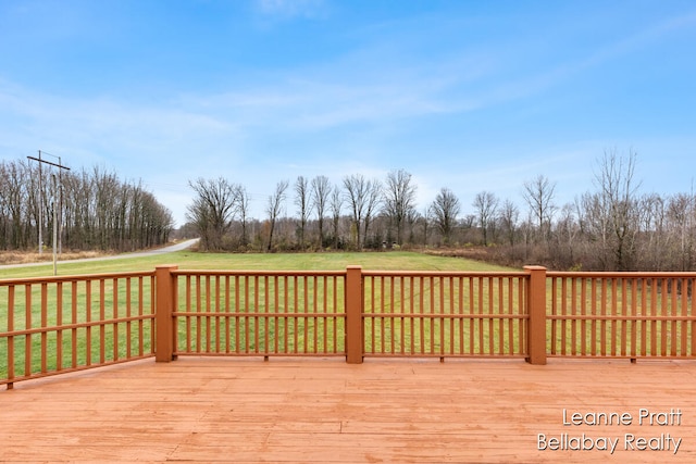 wooden terrace featuring a lawn