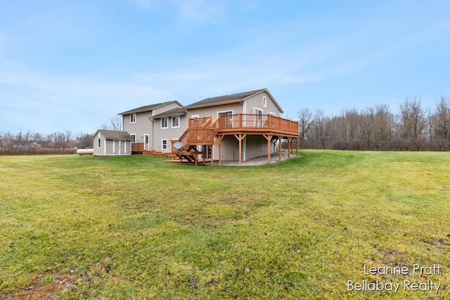 back of house with a lawn, a deck, and a storage unit