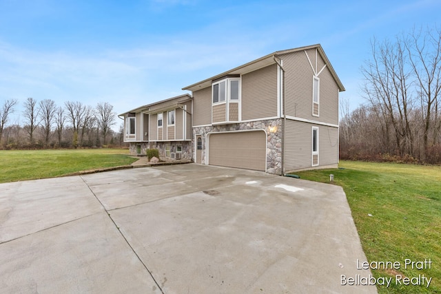 bi-level home featuring a front yard and a garage