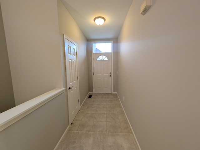 entryway with light tile patterned floors