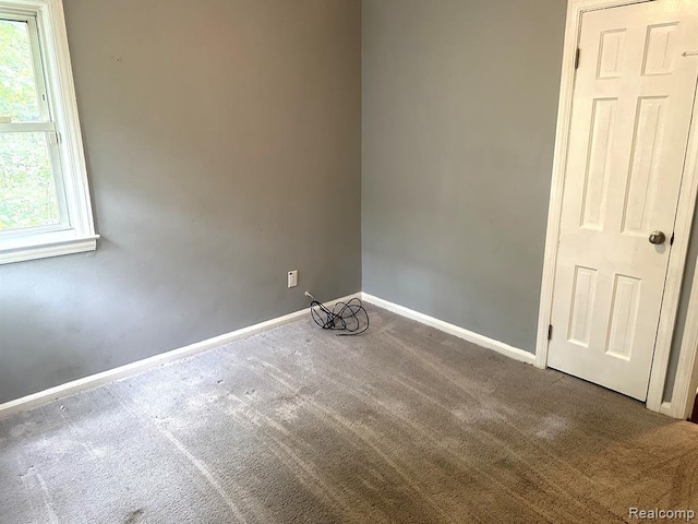 unfurnished room with carpet flooring