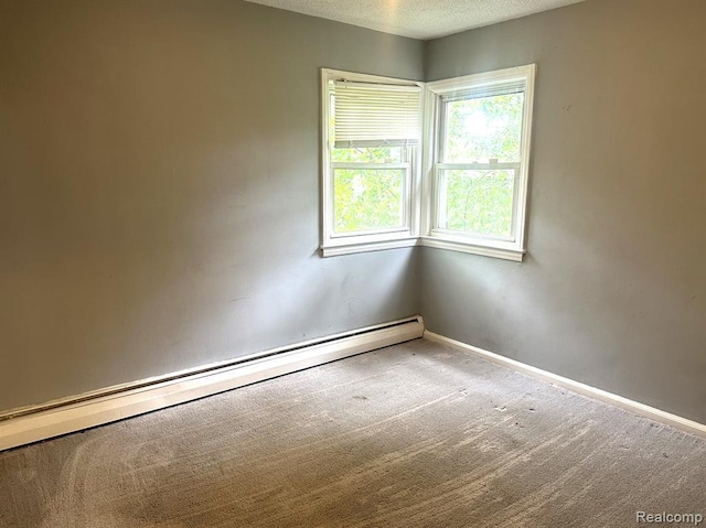 unfurnished room featuring baseboard heating, a textured ceiling, and carpet floors