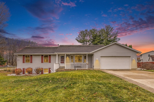 ranch-style home featuring a lawn, a porch, and a garage