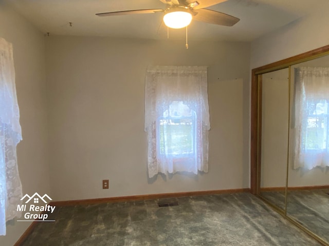 carpeted spare room featuring ceiling fan