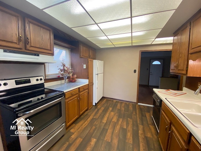 kitchen with dark wood-type flooring, sink, white refrigerator, dishwasher, and stainless steel range with electric cooktop