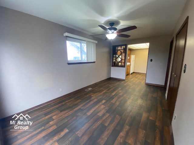 spare room featuring dark hardwood / wood-style floors and ceiling fan