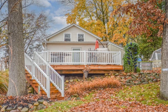 rear view of property featuring a wooden deck