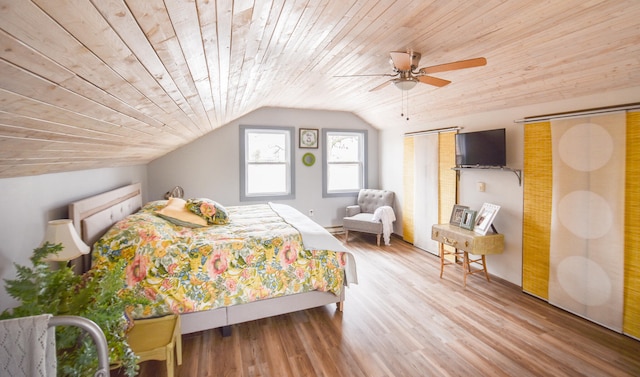 bedroom featuring wood ceiling, ceiling fan, light hardwood / wood-style floors, and vaulted ceiling