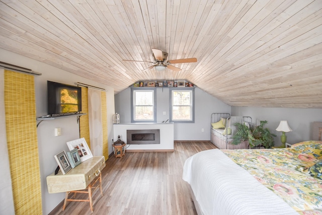 unfurnished bedroom with hardwood / wood-style flooring, ceiling fan, wooden ceiling, and vaulted ceiling