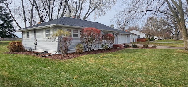 ranch-style home with a front yard and a garage