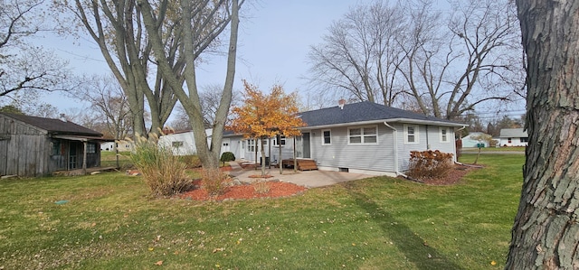 rear view of property featuring a yard and a patio