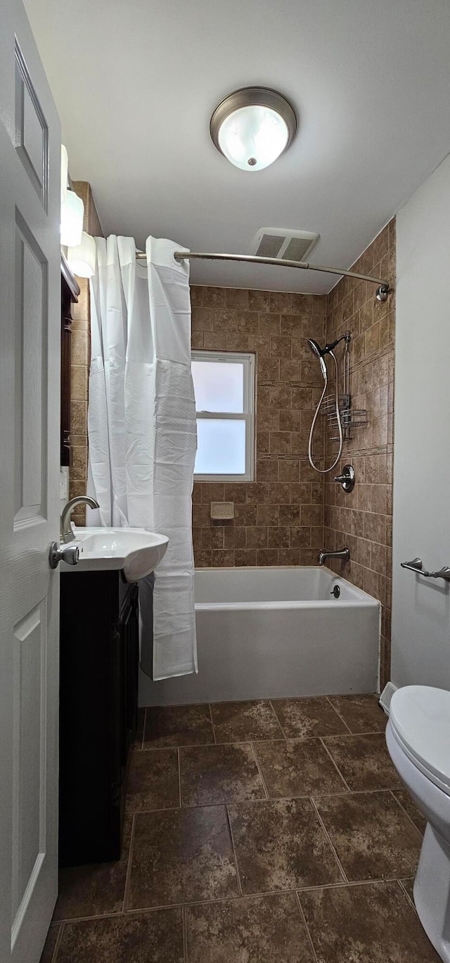 full bathroom featuring shower / bath combo, toilet, and vanity