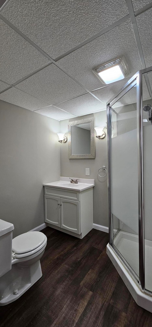 bathroom featuring wood-type flooring, vanity, toilet, and an enclosed shower