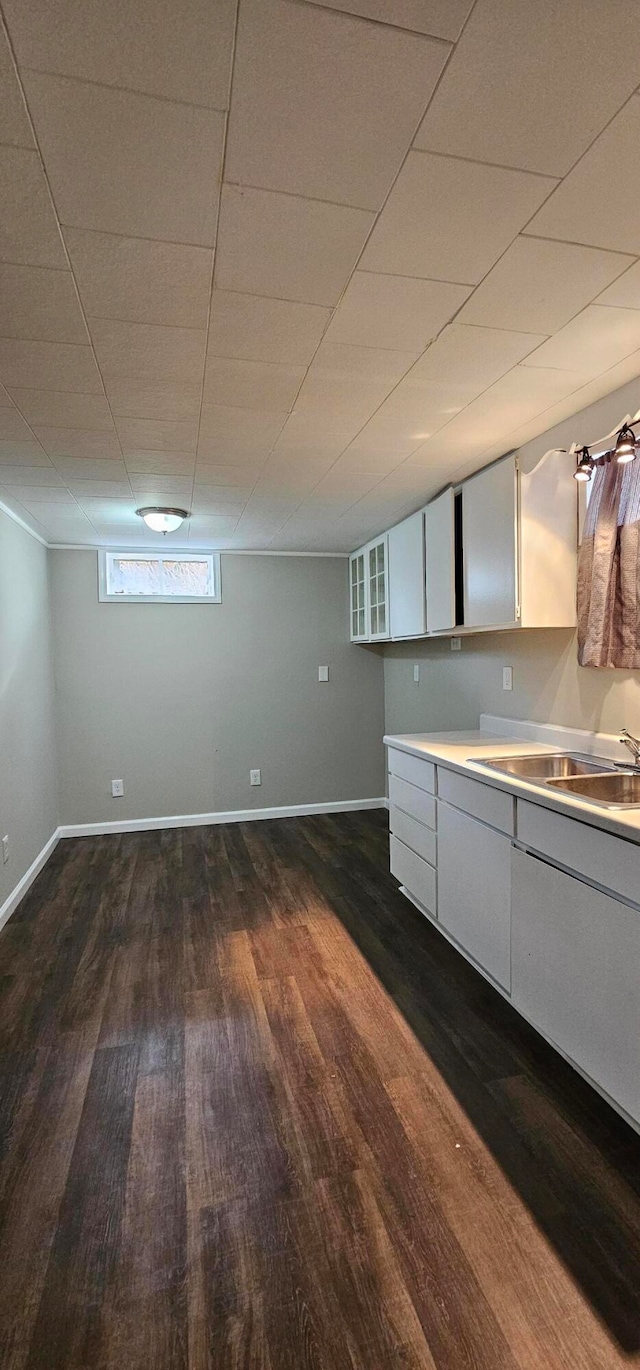 kitchen with sink, white cabinets, and dark wood-type flooring