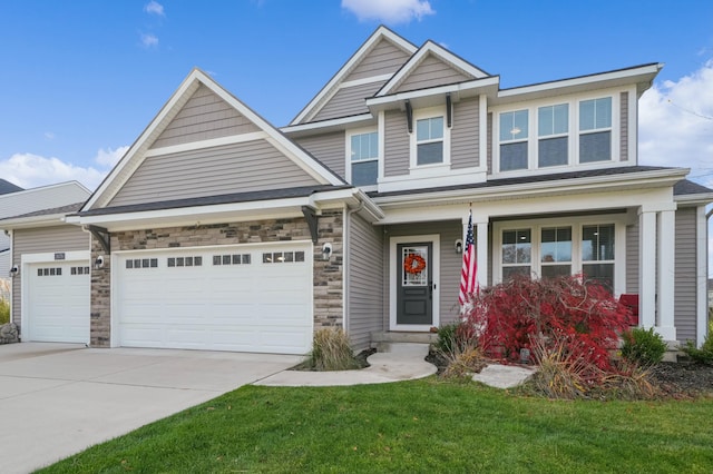 craftsman-style home featuring a front lawn and a garage