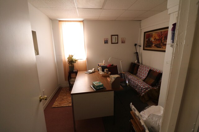 office space with a paneled ceiling