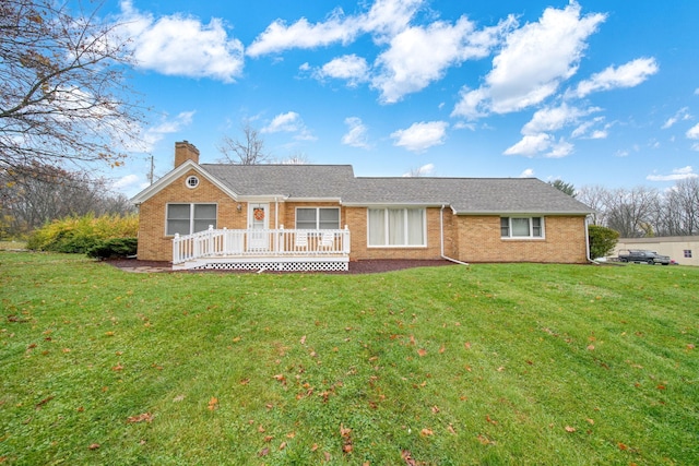 single story home featuring a front lawn and a deck