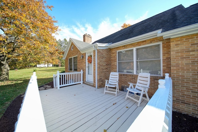 wooden terrace featuring a yard