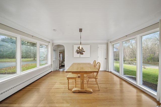 sunroom / solarium with a baseboard radiator and plenty of natural light