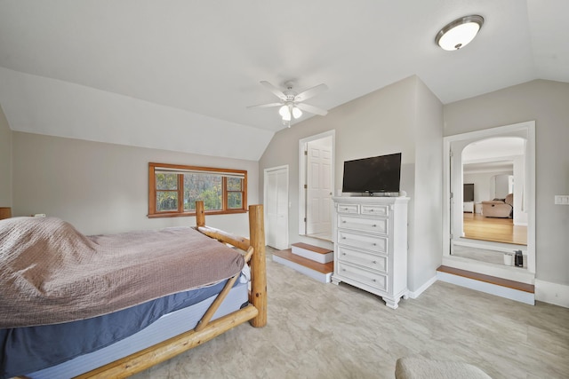 bedroom featuring ceiling fan, a closet, and lofted ceiling