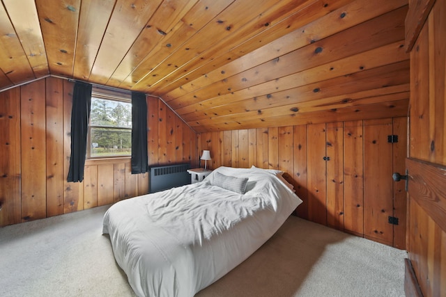 carpeted bedroom featuring radiator, wooden walls, wood ceiling, and lofted ceiling