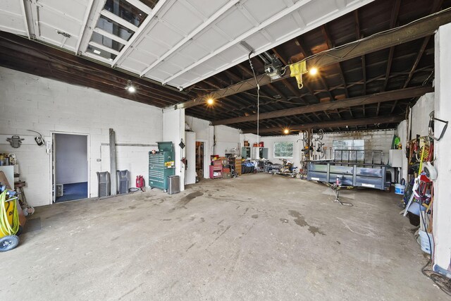 garage featuring a workshop area and gas water heater