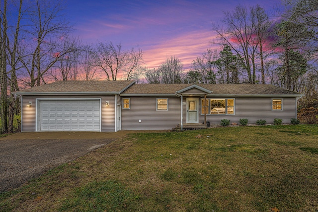 ranch-style home with a lawn and a garage