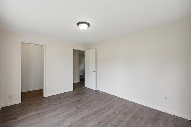 unfurnished room with hardwood / wood-style floors