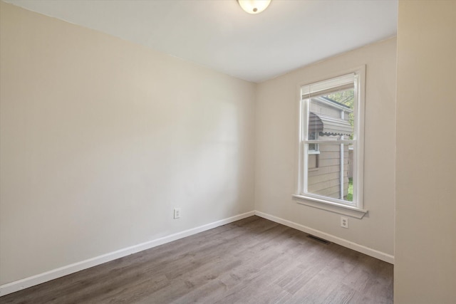 spare room with hardwood / wood-style floors