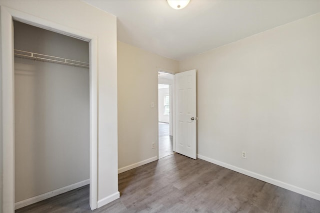 unfurnished bedroom with hardwood / wood-style floors and a closet