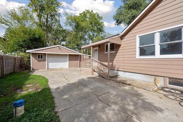 view of side of home with a garage and an outdoor structure