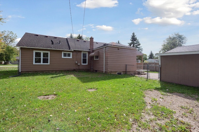 back of property featuring a lawn