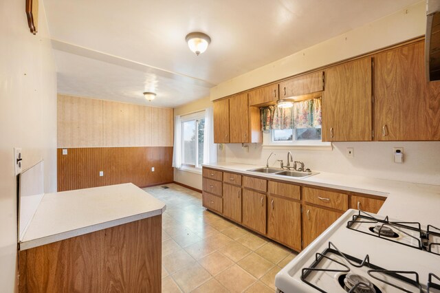 kitchen with white gas range and sink