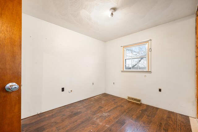 unfurnished room with dark hardwood / wood-style floors