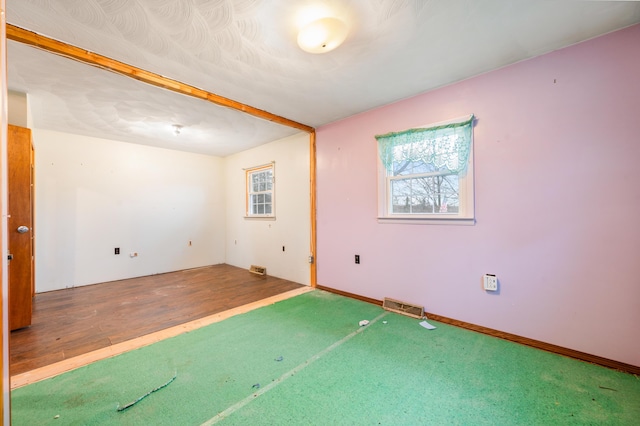 unfurnished room with wood-type flooring