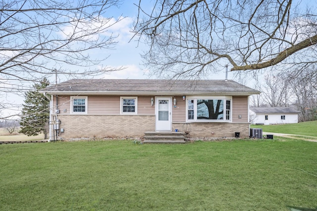 view of front of property with a front yard and cooling unit