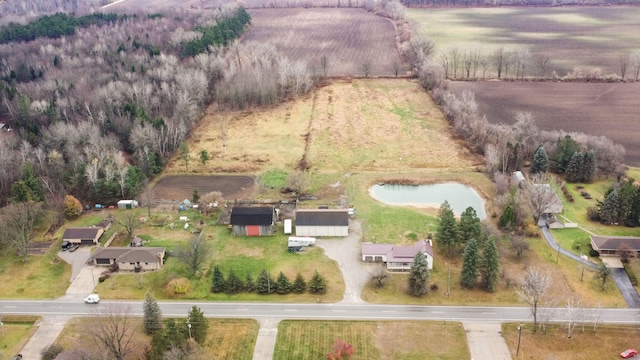 birds eye view of property featuring a water view and a rural view