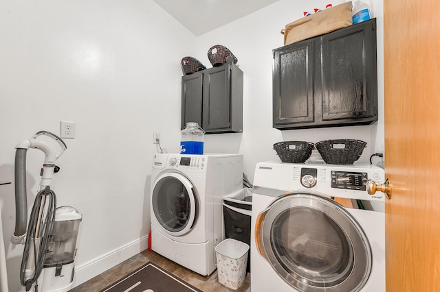 laundry room featuring washer and dryer, dark hardwood / wood-style floors, and cabinets