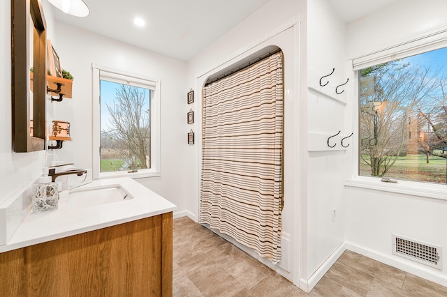 bathroom featuring vanity and walk in shower