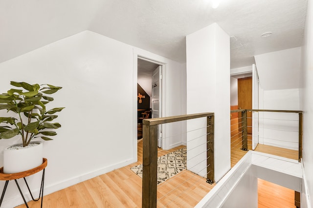 hallway featuring hardwood / wood-style floors and a textured ceiling