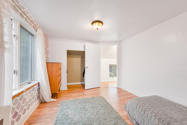 bedroom featuring light wood-type flooring and multiple windows