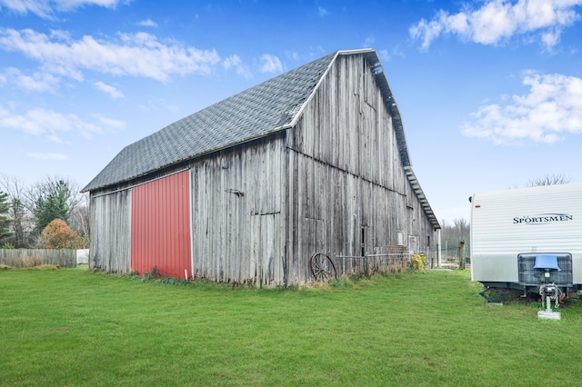 view of outdoor structure featuring a lawn